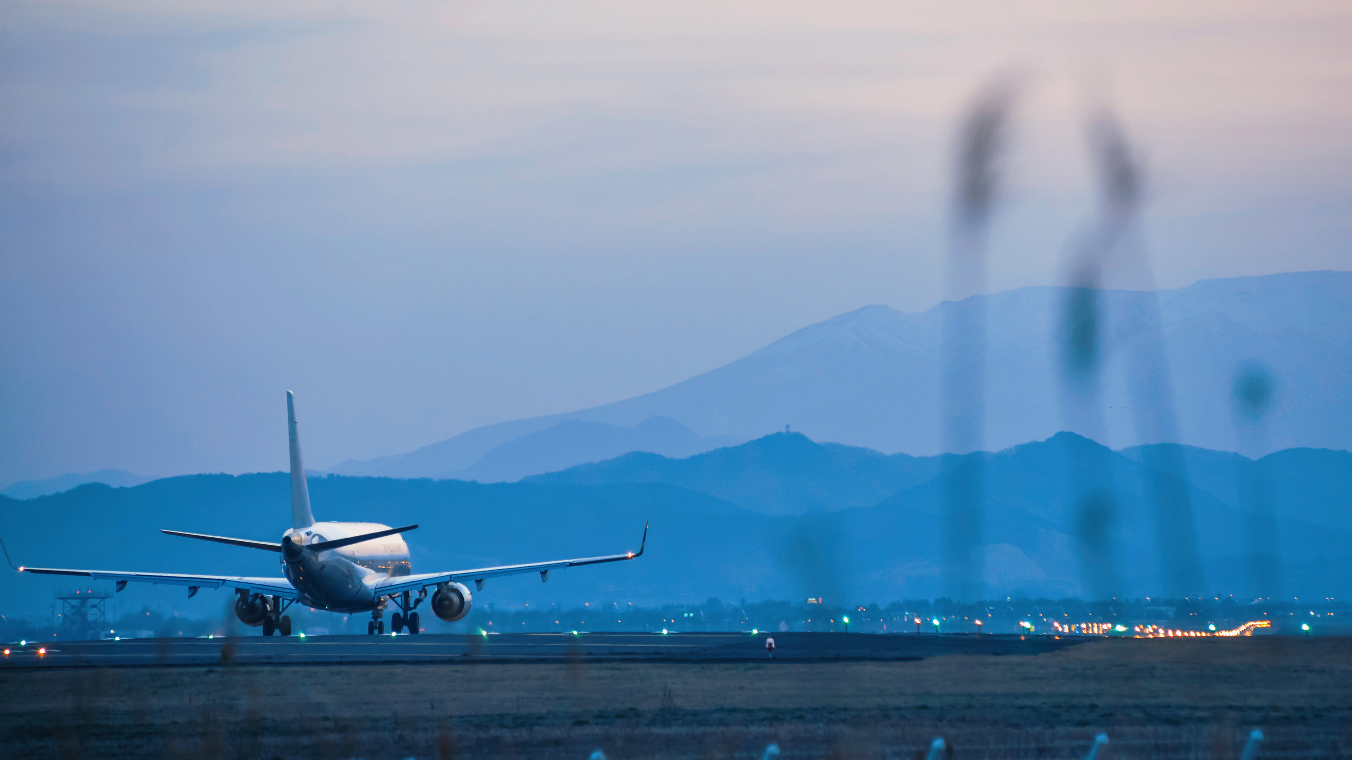 Airplane taking off at dusk runway