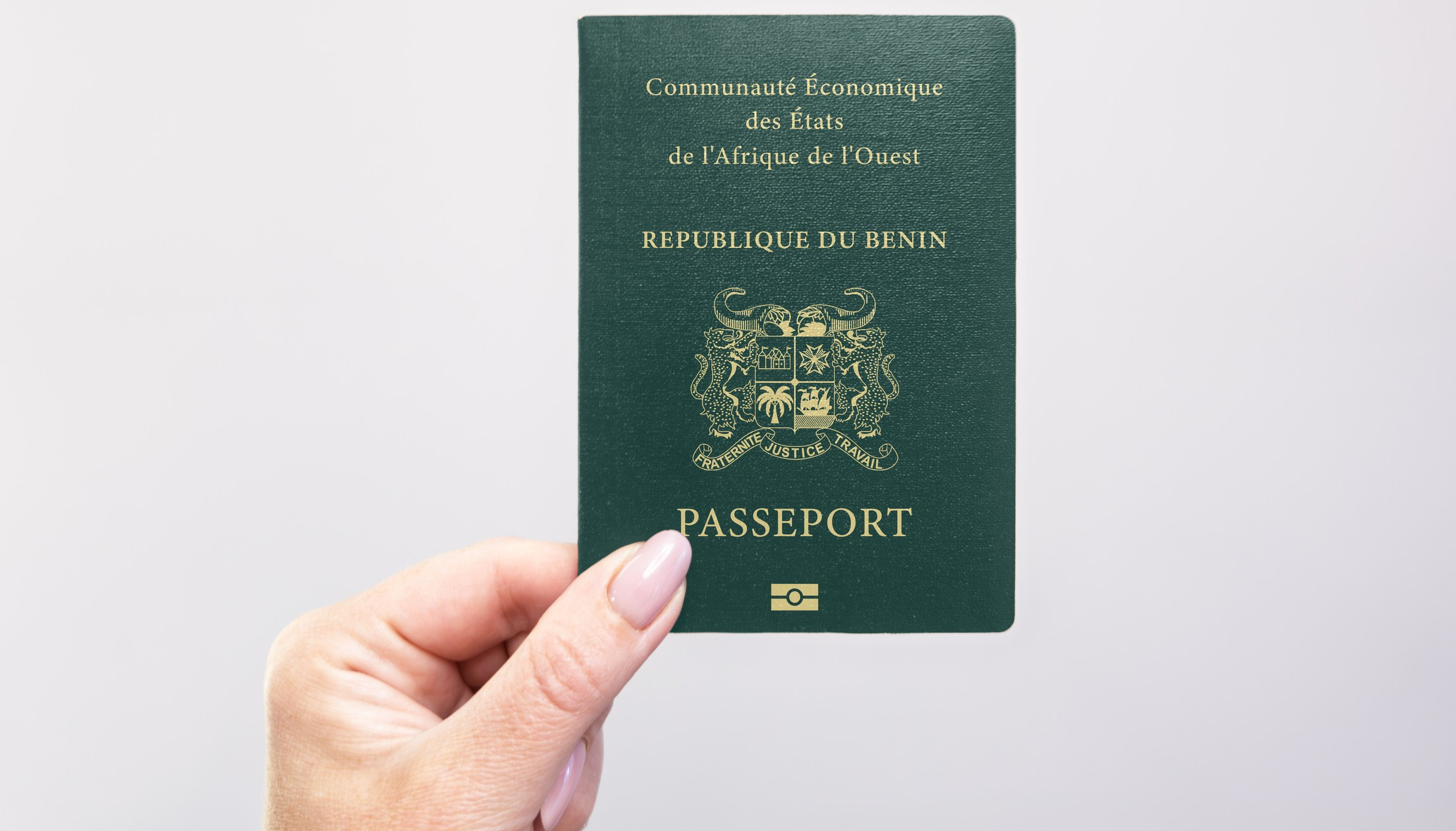 Benin passport held by a hand