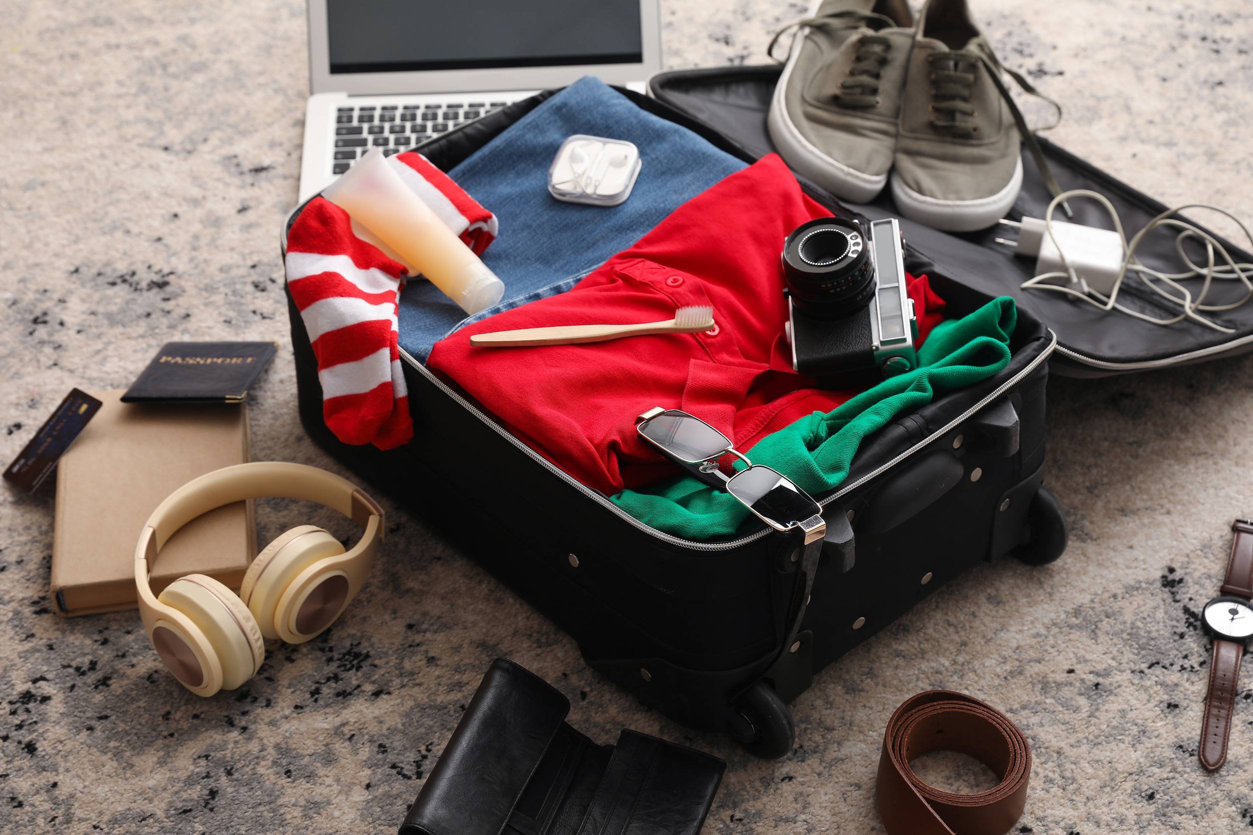 Open suitcase packed with travel essentials